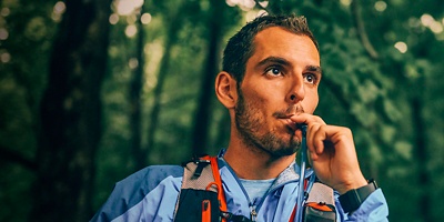 A person drinking out of a hydration reservoir