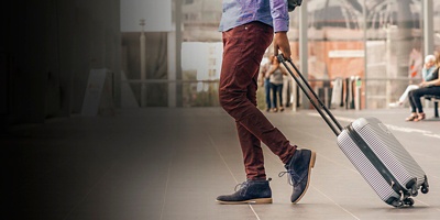 A man traveling with suitcase at the airport 