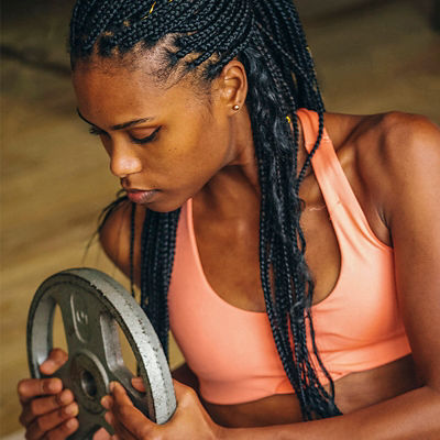 A woman does exercises with a weight