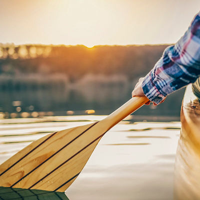 A close up of a canoe paddle in the water