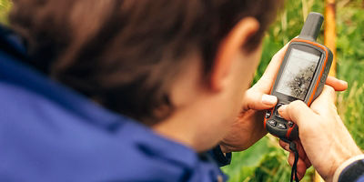 A person checks their satellite messenger