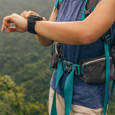 A woman checks her GPS watch during a backcountry trip