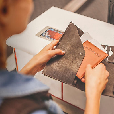A woman takes her passport out of her wallet
