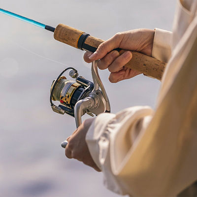 A woman holds a saltwater fishing reel