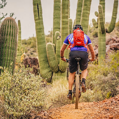 A biker rides Black Canyon's single track in Arizona with a hydration pack