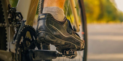 A close up image of a bike pedal and shoe