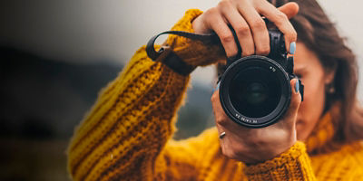 A female photographer take a photo towards the camera