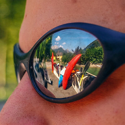 A kayak reflected in a persons sunglasses
