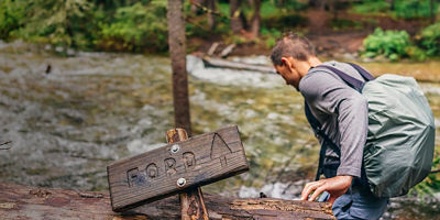 A person fords a river crossing