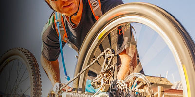 Telluride, Colorado, USA: A male mountain biker fixing his flat tire.