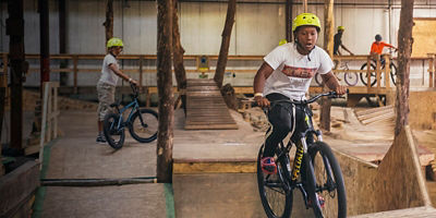 A boy rides a mountain bike at a mountain bike park