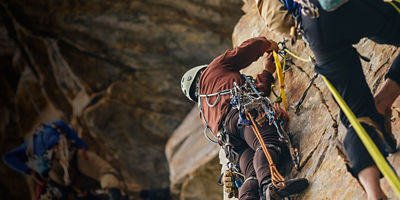 Rock climbers building an anchor on a rock wall
