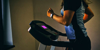 An image of a person running on a treadmill in their home
