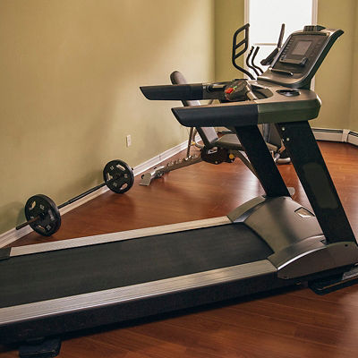 A treadmill sits in a home gym