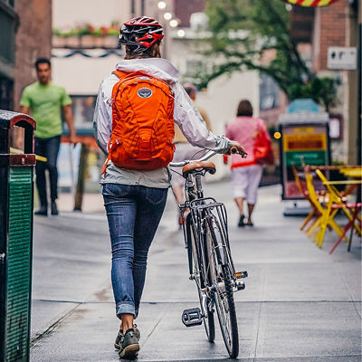 A woman walking her bike through Post Alley in Seattle, WA