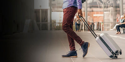 A man traveling with suitcase at the airport 