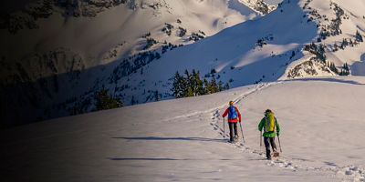 A man and woman snowshoeing on a sunny day, Mt. Rainier National Park, Washington