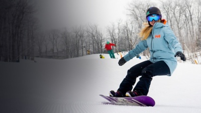 A woman snowboards at Wintergreen Resort 