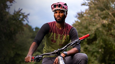 Angelo Wash poses outside with his bike