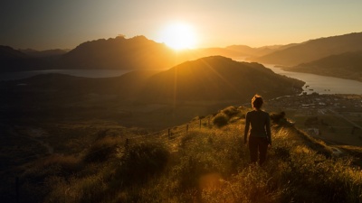 Woman silhouette at sunset on the mountain