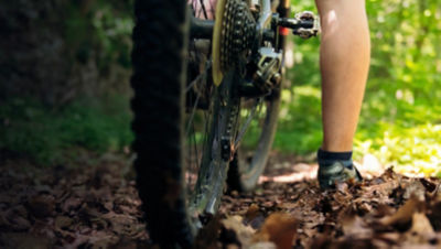Cyclist leg and wheel of a mountain bike