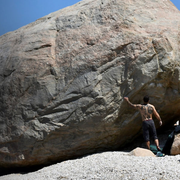 A man looks at a boulder problem at East Marion