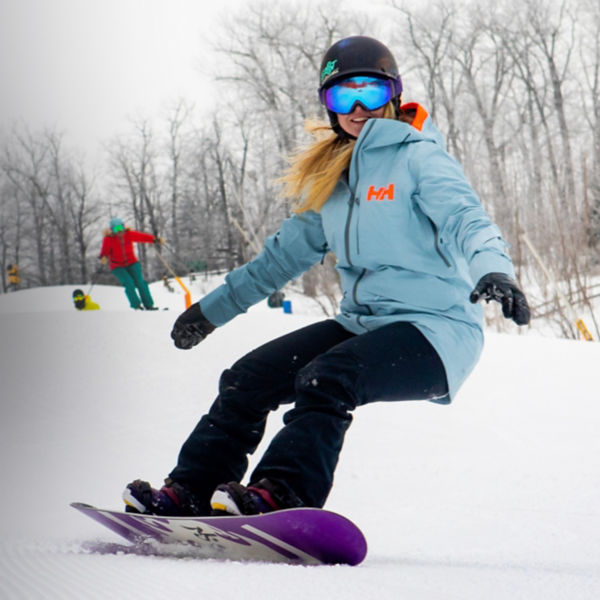 A woman snowboards at Wintergreen Resort 