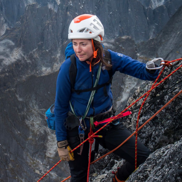 Mo Beck looks on as she rock climbs