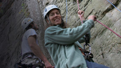 Lynn Hill looks at the camera while belaying