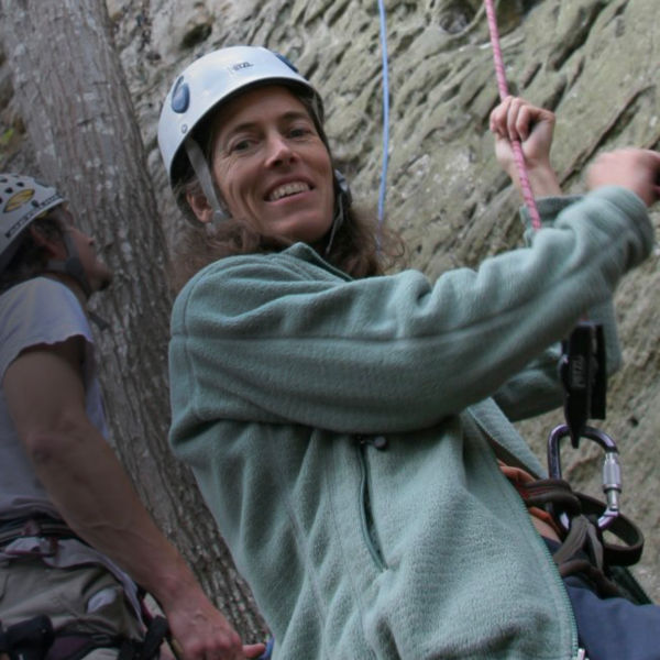 Lynn Hill looks at the camera while belaying