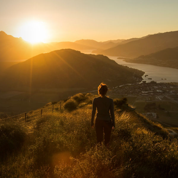 Woman silhouette at sunset on the mountain