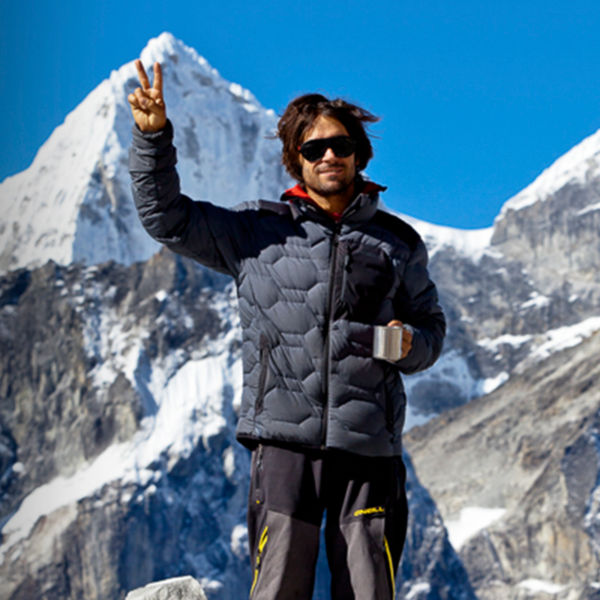 Jeremy Jones poses for the camera in front of a mountain
