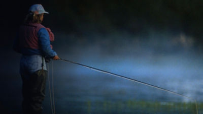 A woman fly fishing in a river