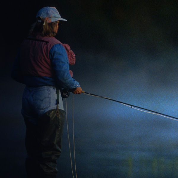 A woman fly fishing in a river