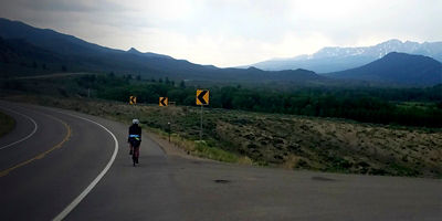 Brooke Barney rides her bike on a road