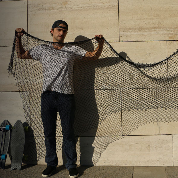 Two men hold up fishing nets