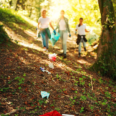 Young activists cleaning up trash in a forest