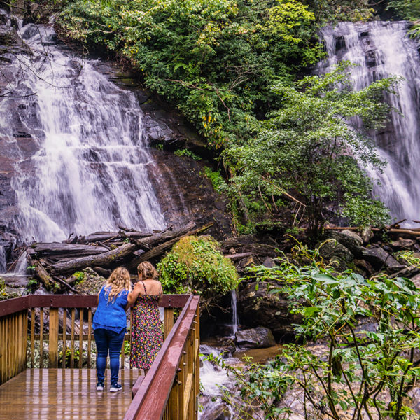 Two women look at Anna Ruby falls in Helen, Georgia