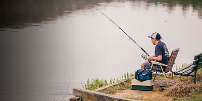 A boy is seen fishing in North Park Lake