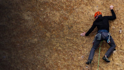 Rock climbers on a rock wall closeup. Climbing gear and equipment