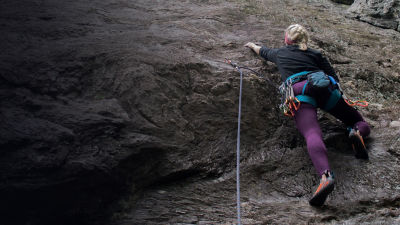 Girl rock climbing at Rumney in New Hampshire