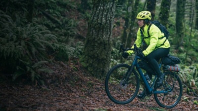 A man bikepacks in the forest