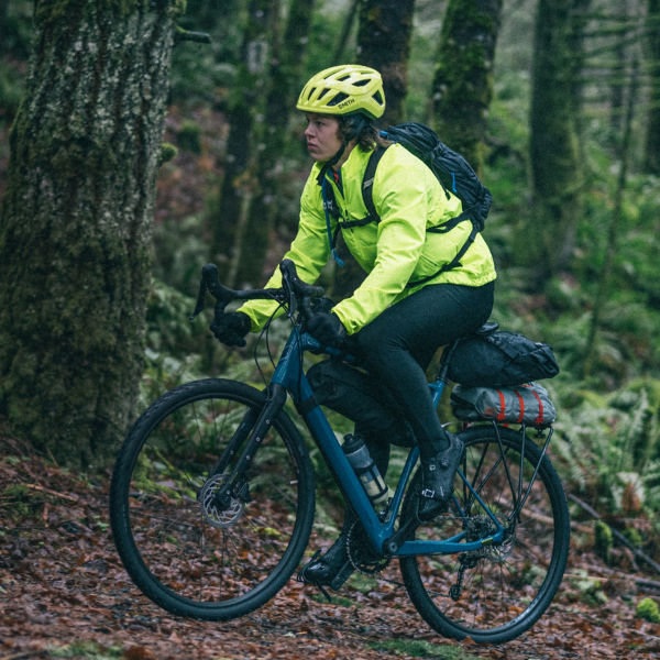A man bikepacks in the forest