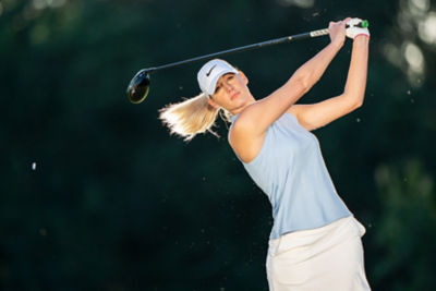 Women swinging a golf club