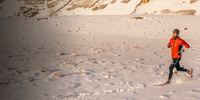 A man running in the Wasatch Mountains near Provo, UT in the winter