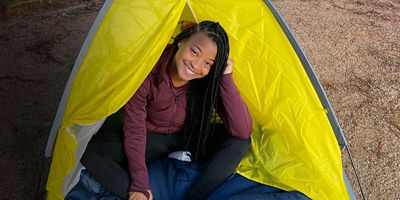 Brittany Coleman sitting in a tent