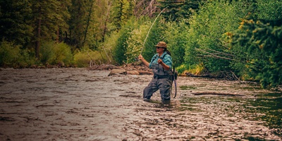 Erica Nelson fly fishing in the river