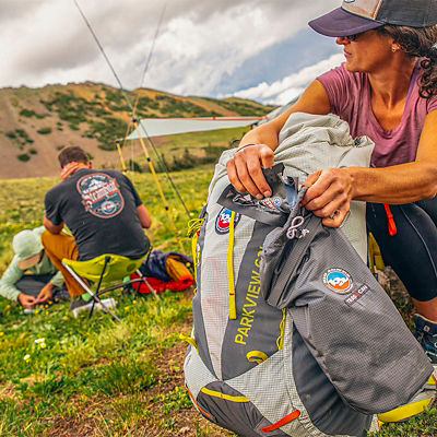 Nicole Jackson looks up for birds holding binoculars while birdwatching