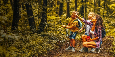 Children hiking in mountains or forest with sport hiking shoes.