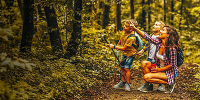 Children hiking in mountains or forest with sport hiking shoes.